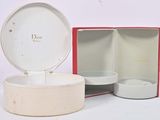 a white box with a red lid sitting on a white surface