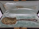 a silver spoon in a case on a table