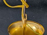 a small brass bell with a wire attached to it