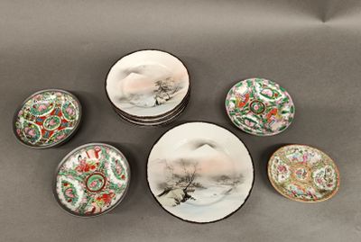 several plates and bowls with asian designs on them on a table