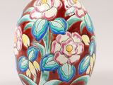 a colorful vase with flowers painted on it on a white background