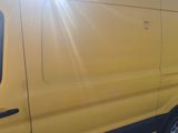 a yellow van that is parked on the side of the road