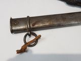 a metal pipe with a metal ring on it next to a knife