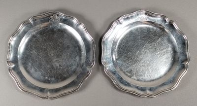 pair of silverplated plates with scalloped edges on a white surface