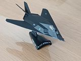 une maquette d'avion de chasse posée sur une table en bois