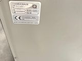 a metal box with a label on it sitting on a pallet