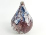 a small vase that has a blue and brown design on it