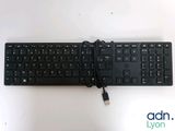 a black keyboard that is connected to a charger