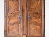 an antique wooden armoire with carvings on the doors and drawers