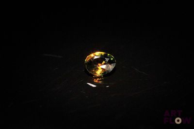 a close up of a glass ball on a table in the dark
