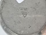 a close up of a silver plate with a triangle on it