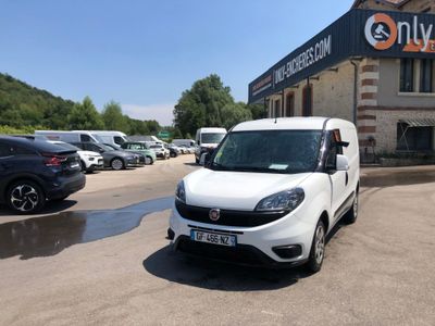 the white van is parked in front of a building with many cars parked in front of it