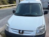 a small white van parked on the side of the road