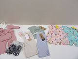 a lot of baby clothes that are on a table