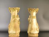 two vases that are sitting on a table