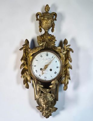 a clock that is hanging on the wall next to a wall