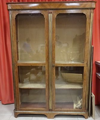 a cabinet that has a glass door on top of it