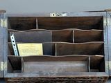 a wooden desk with a pen and paper holder on it