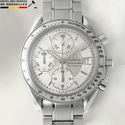 a close up of a watch on a white surface