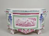 a large white and green planter with a painting on it