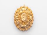 an image of a gold broochle on a white background