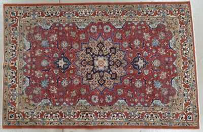 a red rug with a medallion design on it