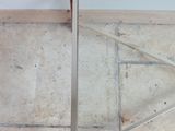 an image of a glass and metal coffee table on a tiled floor