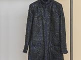 une photo d'un manteau suspendu à un portant