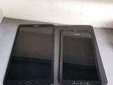 two cell phones sitting next to each other on a table