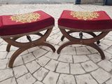 two red stools with gold designs on them