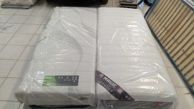 two mattresses sitting on top of each other in a store