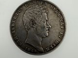 a silver coin with a man ' s face on it