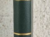 a green book that is sitting on a table