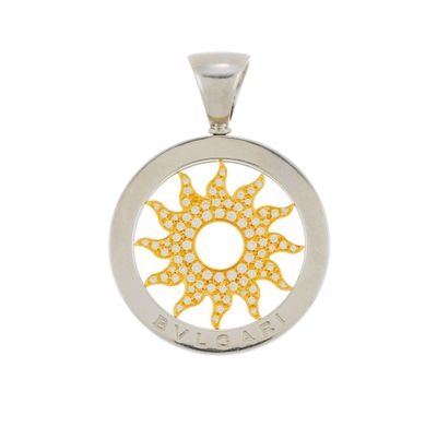 a close up of a yellow and white sun pendant on a white background