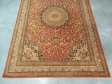 an orange rug with a medallion design on it