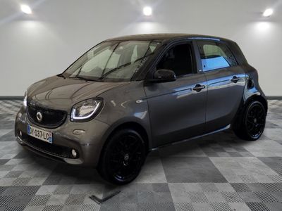 the smart car is parked on a checkered floor in a garage