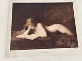an old photo of a nude woman reading a book on a bed