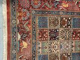 an antique persian rug with a patchwork design on a blue background