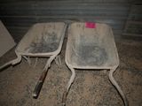 two dirty chairs sitting next to each other in the dirt