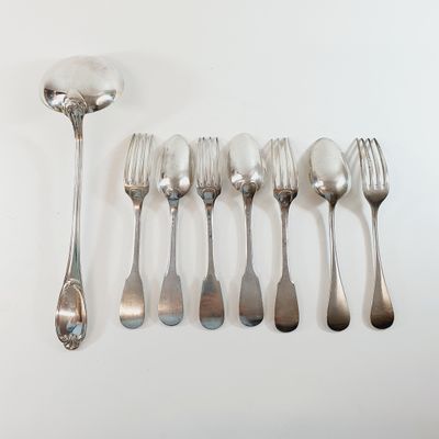 a lot of silver spoons and forks on the table