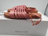 a pair of pink sandals sitting on top of a white box