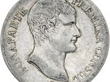 a close up of a coin with a man ' s face on it