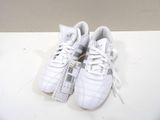 pair of white tennis shoes on a white surface with a white background