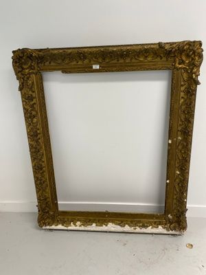 an old picture frame sitting on the floor next to a wall