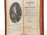 an old book with a picture of a man holding a cat