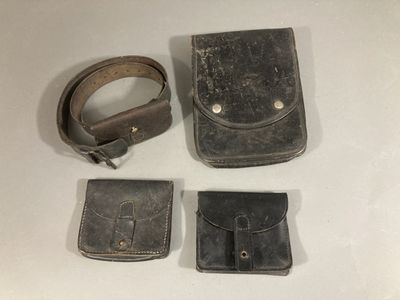three pieces of leather are sitting on a table next to each other