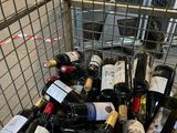 many bottles of wine in a shopping cart in the store