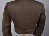 the back of a brown jacket on a mannequin stand