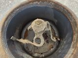 a metal object in the middle of a green pot