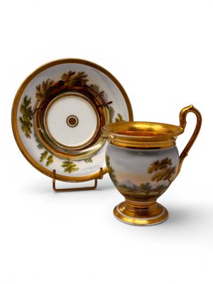 an image of a cup and saucer sitting on a white surface